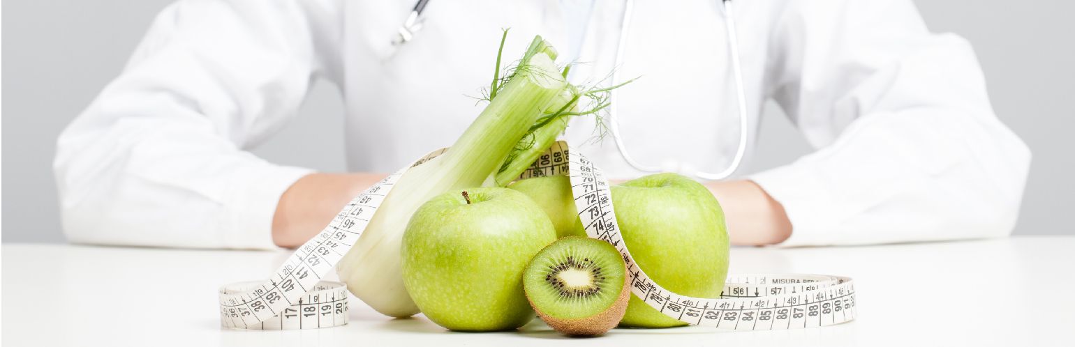 Nutritionist female Doctor in her office. Focus on fruit